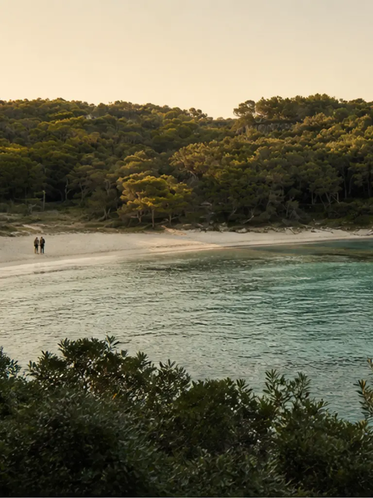 Cala Macarella turquoise quiet cove in Menorca at soft golden hour, quiet-luxury proposal atmosphere