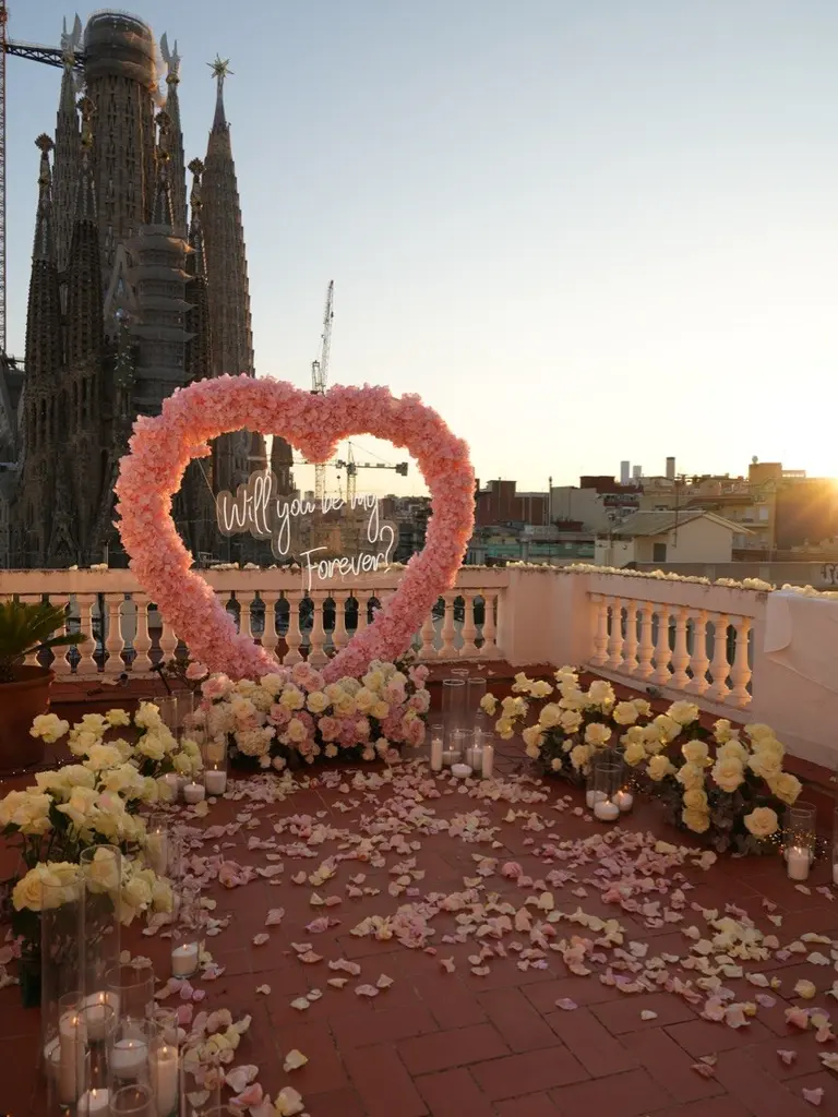 Sagrada Familia rooftop proposal setup in Barcelona showing floral arch and view 1